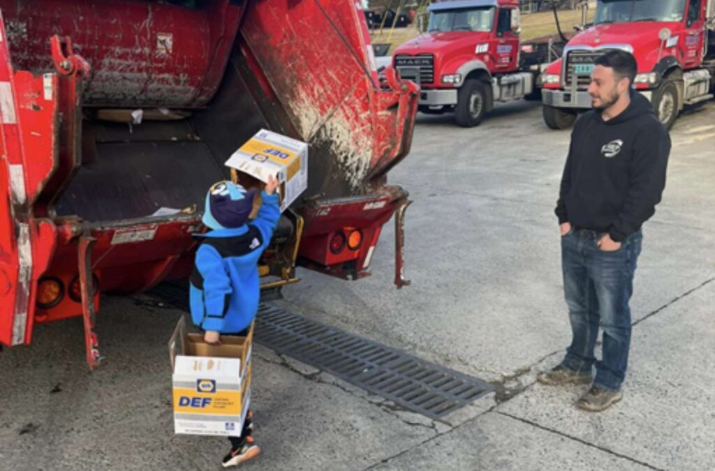 A Hiep Sanitation worker delivering a dumpster to a local business in Rockland County, NY, emphasizing personalized customer service and local expertise, Dumpster Rental Near Me.