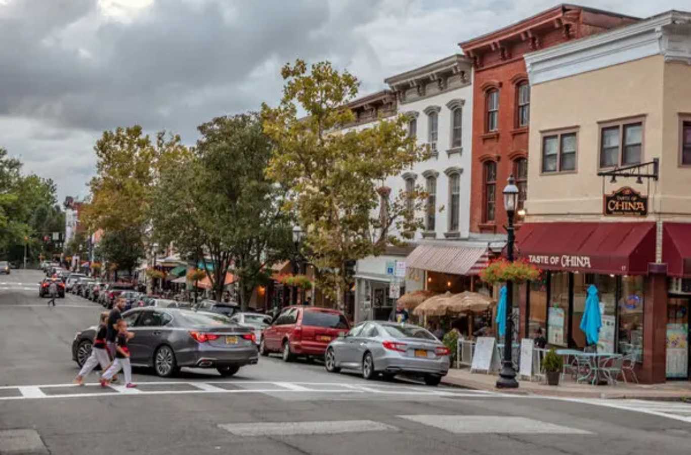 A Hiep Sanitation dumpster in front of a historic building undergoing restoration in Tarrytown, NY, contributing to preservation and clean-up efforts.