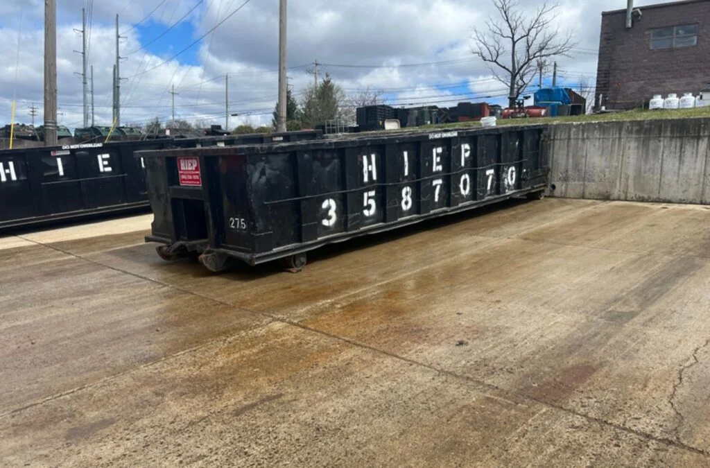 Hiep Sanitation team picking up a dumpster from a job site in Yonkers, NY, providing reliable service. Dumpster Rental Near Me.