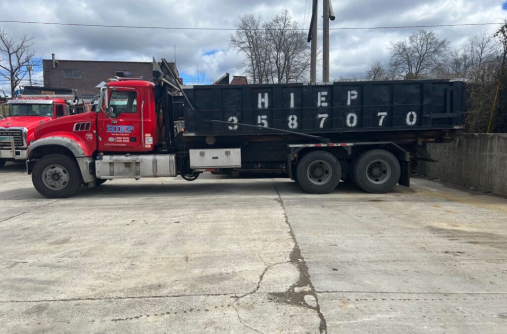 A Hiep Sanitation team member assisting a customer with a dumpster rental in Fort Montgomery, NY, highlighting efficiency and convenience.